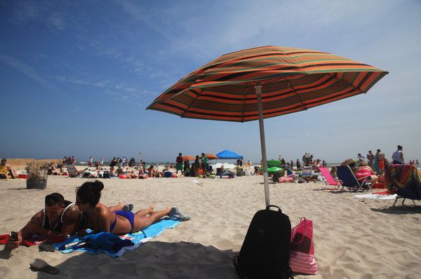 Summer Shows Its Stripes Woven In Orange Green And Brown The Traditional Orange Green And Brown Umbrellas That Dot White Sand Of Jones Beach On Long Island Are Life Work One Woman Chris Ann Peters