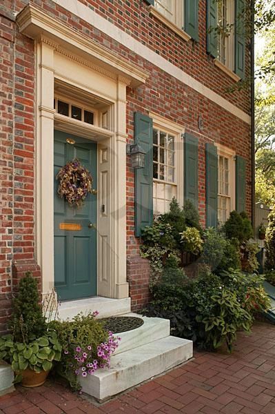 brick house with green shutters