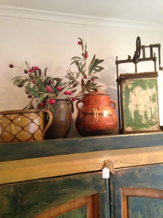 Decorative pots are impressive accents for the top of the armoire