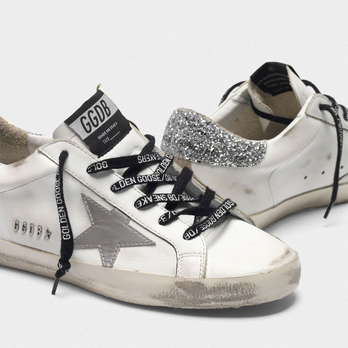 superstar sneakers with silver heel tab with glitter and metal stud lettering