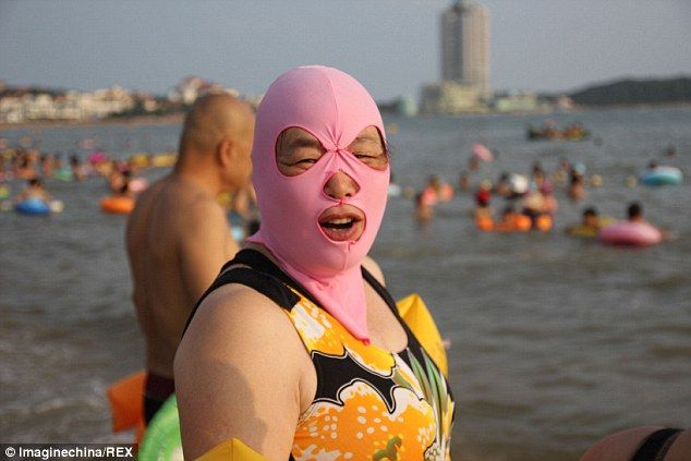 Covered Up A Woman Wearing A Balaclava Style Face Mask At A Beach Qingdao Shandong Province China Face Scuba Girl Kini Covered Up A Woman Wearing A Balaclava Style Face Mask At A Beach Qingdao Shandong Province China Face Scuba Girl Kini