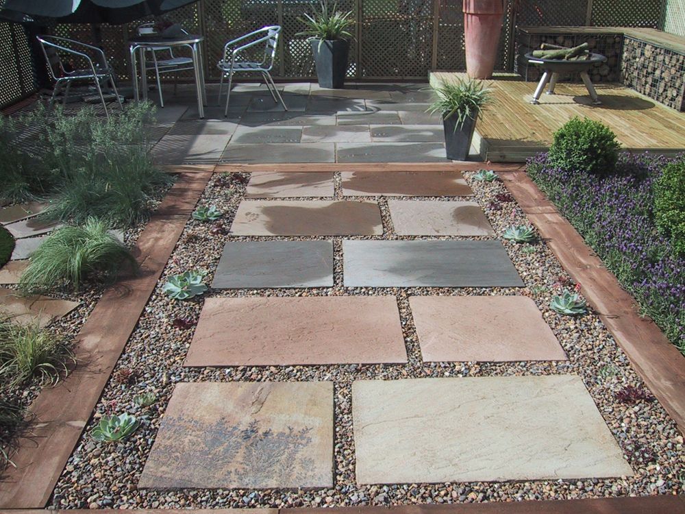 Stepping stones in gravel, patio area and raised deck with ...