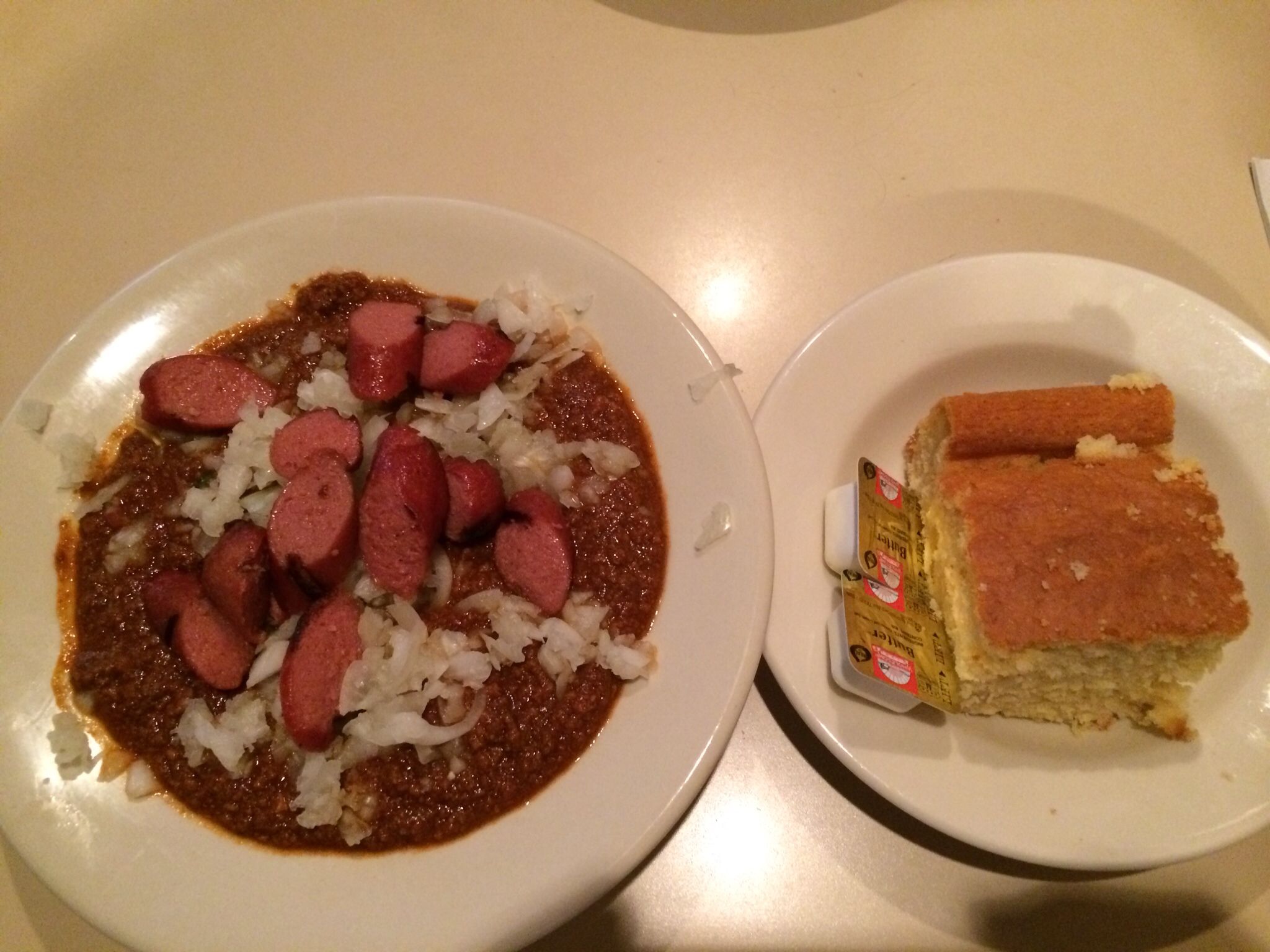 Cincinnati chili topped with chopped onions and grilled Cincinnati chili topped with chopped onions and grilled
