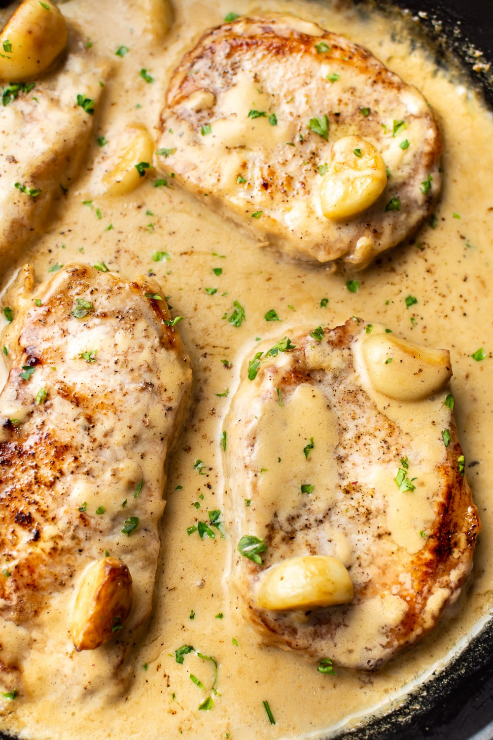 These pork chops are seared to perfection and smothered in a creamy garlic sauce. Perfect with mashed potatoes! Pork Chops And Potatoes, Easy Pork Chops, Baked Pork Chops, Mashed Potatoes, Smothered Pork Chops Recipe, Cooking Pork Chops, Creamy Garlic Chicken Recipes, Creamy Garlic Sauce, Boneless Pork Chop Recipes