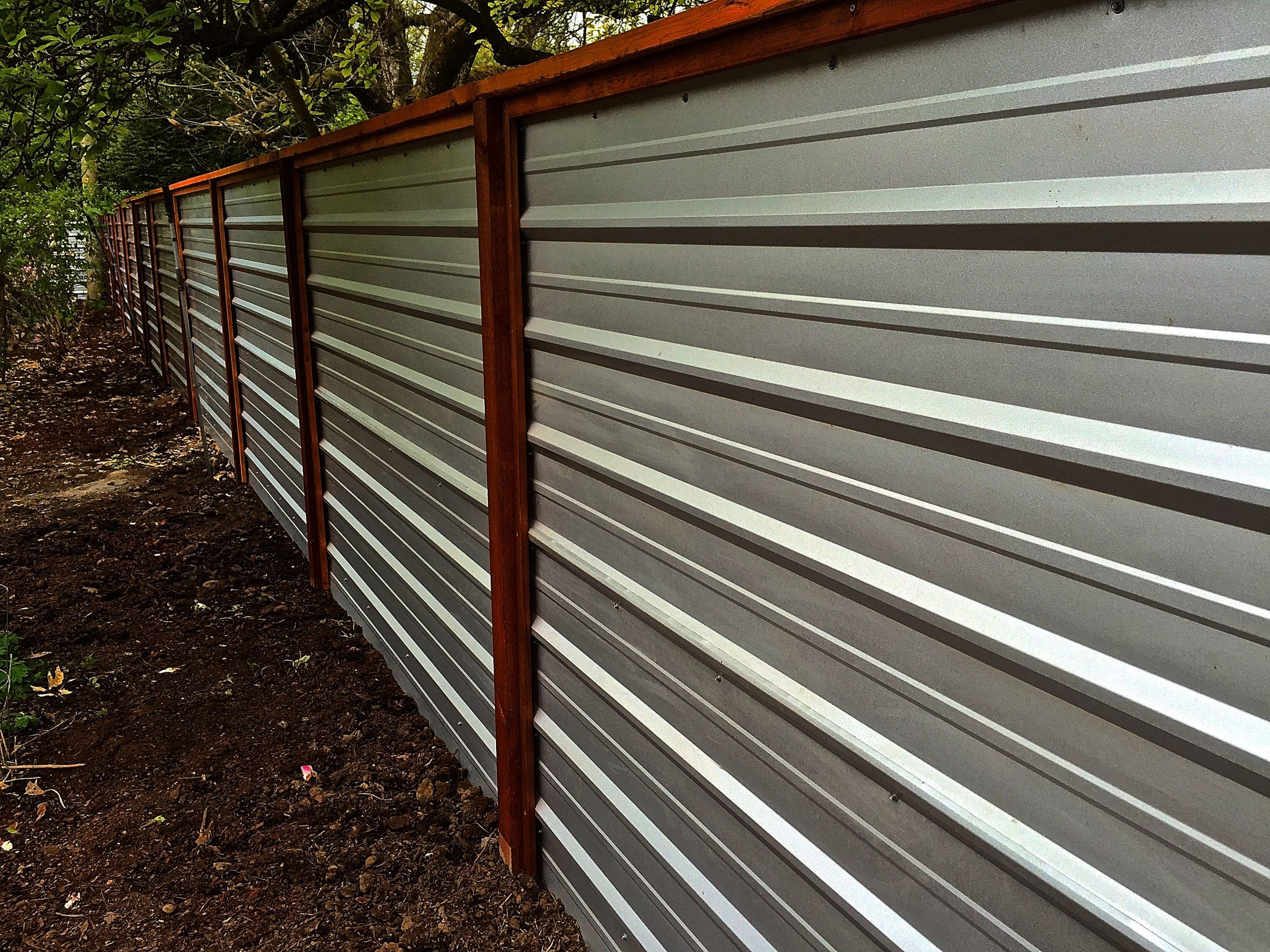 A Galvanized Corrugated Metal Fence Creates A Clean Modern Edge A Galvanized Corrugated Metal Fence Creates A Clean Modern Edge