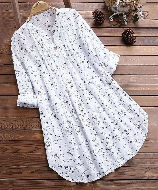 White Floral Button-Up Tunic - Women. Pair this whimsical button-up with your favorite jeans or leggings for fresh style that's ready to stroll through the farmer's market or browse shops. Breathable cotton-blend fabric keeps it feeling fresh and comfy. Size note: This item runs small. Ordering one size up is recommended.Size M: 34.25'' long from high point of shoulder to hemKnit65% cotton / 35% polyesterMachine washImported Long Sleeve Floral Top, Long Sleeve Casual, Long Sleeve Tops, Long Sleeve Shirts, Loose Shirts, Womens Tunics, Blouses For Women, Long Tunics For Women, Cotton Tunics For Women