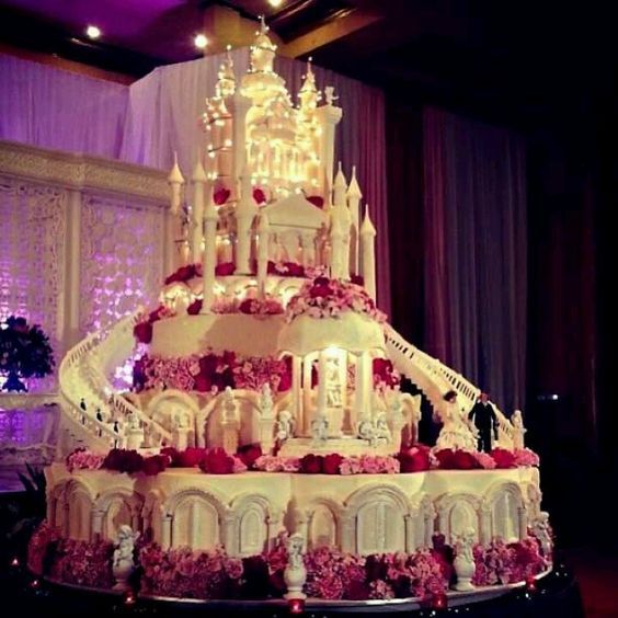 multi tiered royal castle wedding cake with stairs lights and windows