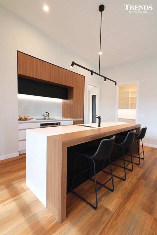 Every room in the house should be a favourite space. This simple kitchen at the Christchurch Landmark Homes show home features a TriStone benchtop in Antarctic Snow, doors and panels in AGT Melamine soft-touch White, and Black in the lower back wall units, and Melteca Oiled Legno woodgrain. A simple and modern aesthetic to resonate with a design-savvy homeowner. Visit Trends Kitchens today to get started on your kitchen or joinery project. Kitchen Room Design, Kitchen Style, Home Decor Kitchen, Modern Kitchen Design, Kitchen Interior, Home Kitchens, White And Timber Kitchen, Laminate Kitchen, Laminate Benchtop