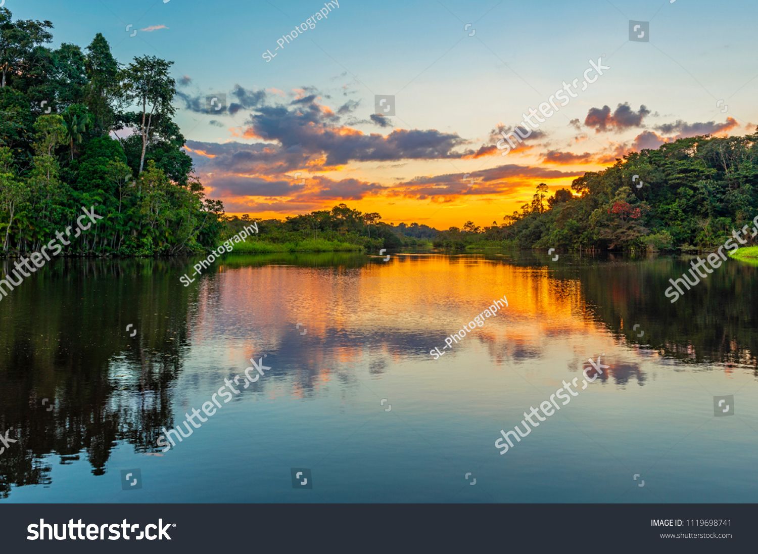 Reflection Of A Sunset By A Lagoon Inside The Amazon Rainforest