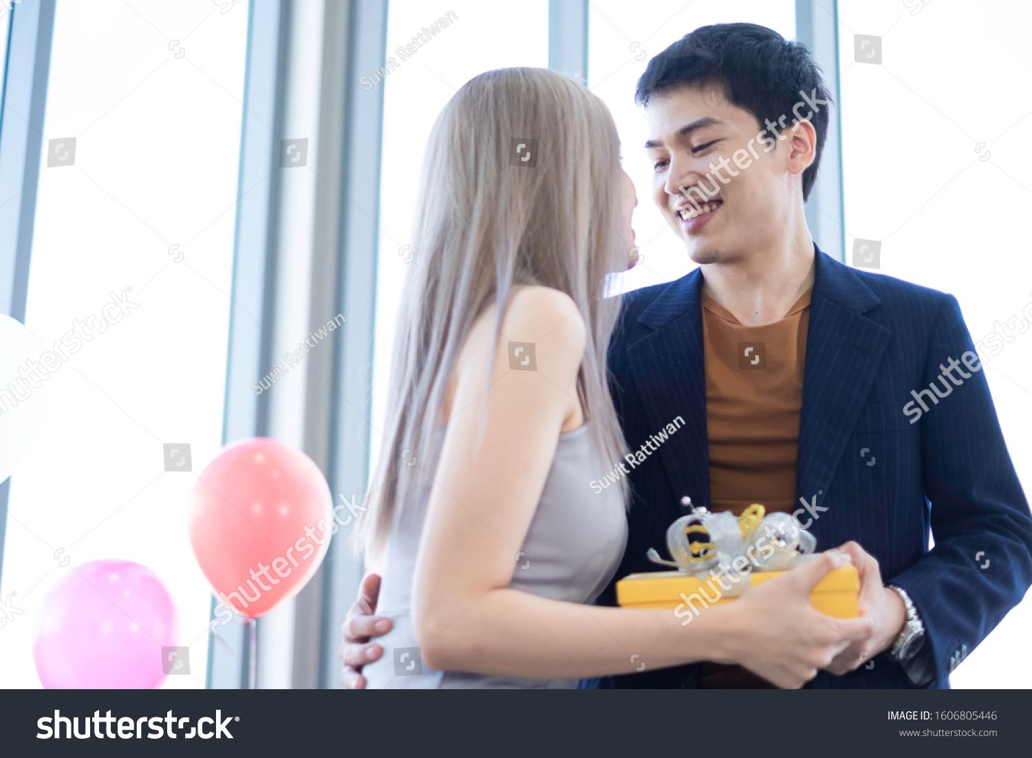 Asian Romantic Couple Giving Surprise Gifts To Celebrate Romance