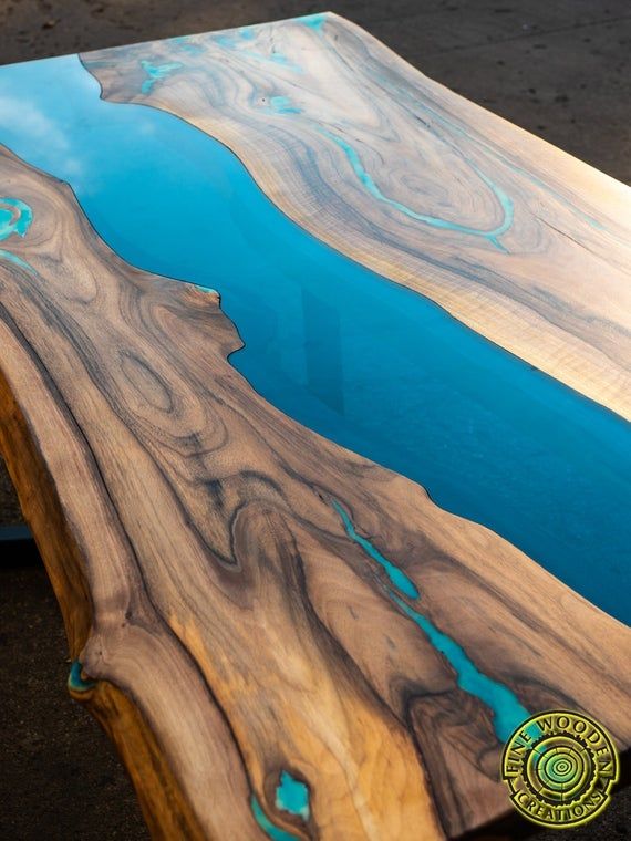 Live edge river dining table with turquoise glowing resin