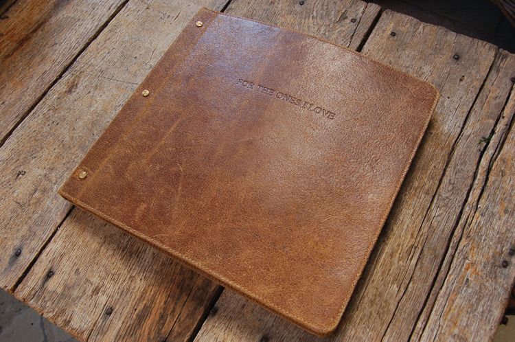 this gorgeous photo album is handcrafted with distressed leather and vintage looking photo albums