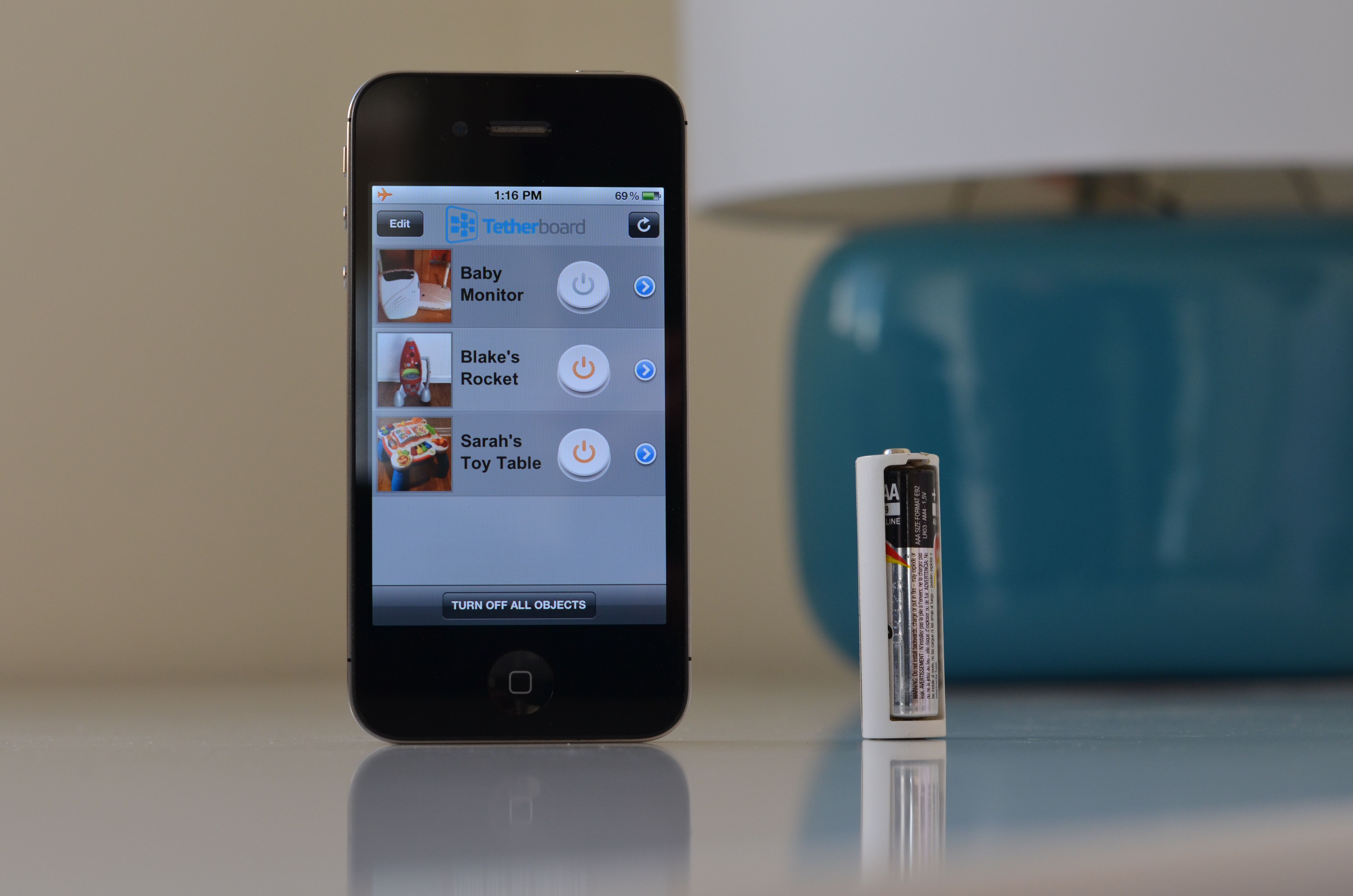 Tethercell AA Battery Adapter Beside Iphone 4S