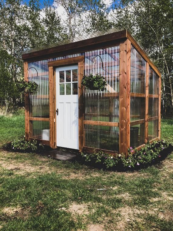 A how-to guide that will help you build your very own lean-to style greenhouse! This guide was created after I shared a photo of this greenhouse on a plant and home décor group that I follow online. I received a flood of requests for a material list and a design plan from so many of you so I created Backyard Greenhouse, Backyard Garden, Diy Garden, Home And Garden, Greenhouse Ideas, Small Greenhouse, Pallet Greenhouse, Backyard Landscaping Plans, Backyard Plan