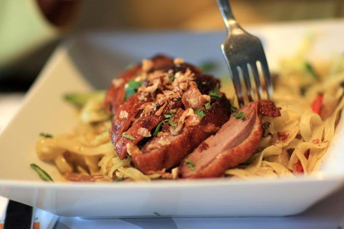 A White Plate Topped With Pasta And Meat Next To A Fork On Top Of It A White Plate Topped With Pasta And Meat Next To A Fork On Top Of It