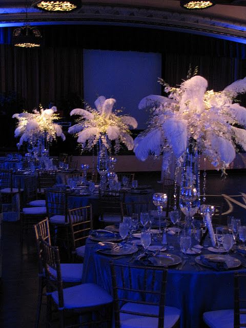 Centerpieces Bursting With White Orchids And Feathers