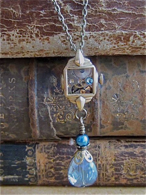 Steampunk necklace One-of-a-Kind Handcrafted Jewelry Created with Recycled Vintage Watch Parts and Found Objects This necklace incorporates a beautiful vintage gold filled watch case with a vintage jeweled watch movement inside. It is finished off with a vintage crystal drop and Aqua Marine Swarovski crystal. Very elegant. This pendant is approx. 2 and 3/4 inches long and hangs from a 20 inch antique bronze toned necklace. It is very beautiful, the pictures do not do it justice. Please note that Vintage Jewelry Repurposed, Vintage Jewelry Crafts, Upcycled Jewelry, Old Jewelry, Art Deco Jewelry, Handcrafted Jewelry, Custom Jewelry, Antique Jewelry, Jewelry Making
