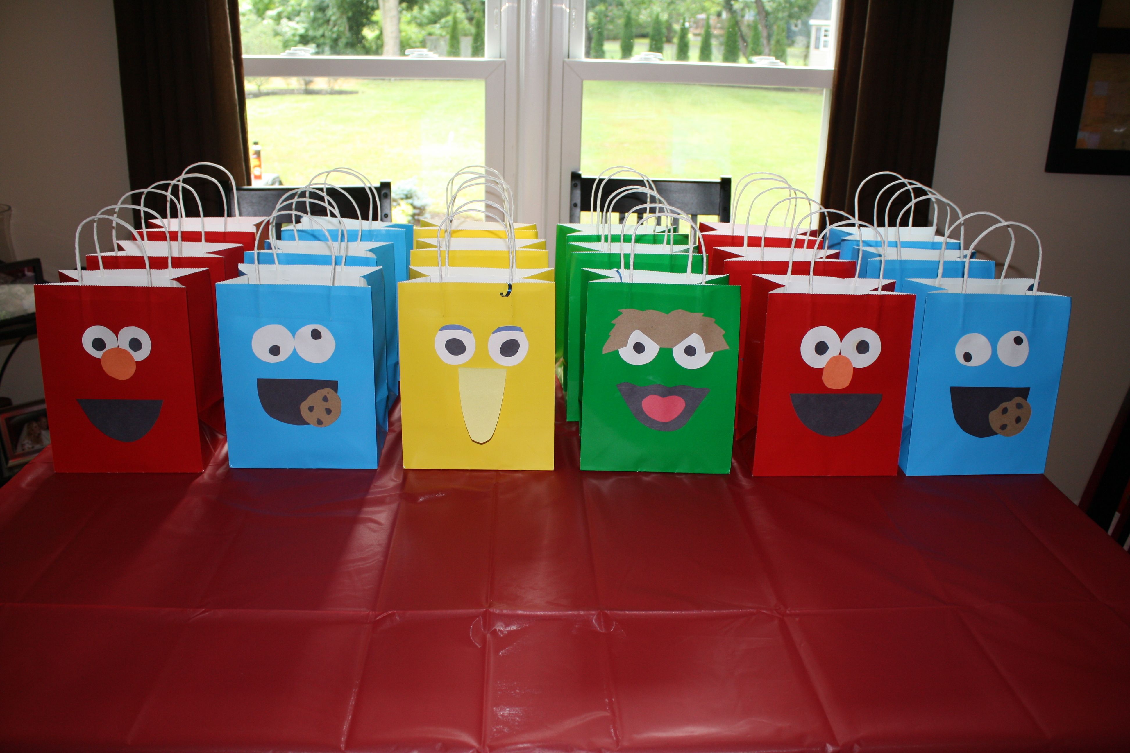 Sesame Street favor bags filled with a different item from each character- cookie from cookie monster, teddy bears (grahams) from Big Bird, Wands (Pretzel Rods dipped in chocolate with sprinkles) from Abby, Worms (Gummy Worms) from Oscar, and Goldfish from Elmo Sesame Street Party, Sesame Street Birthday, Elmo Birthday Party, Pretzel Rods, Gummy Worms, Big Bird, Favor Bags, Cookie Monster, Christians