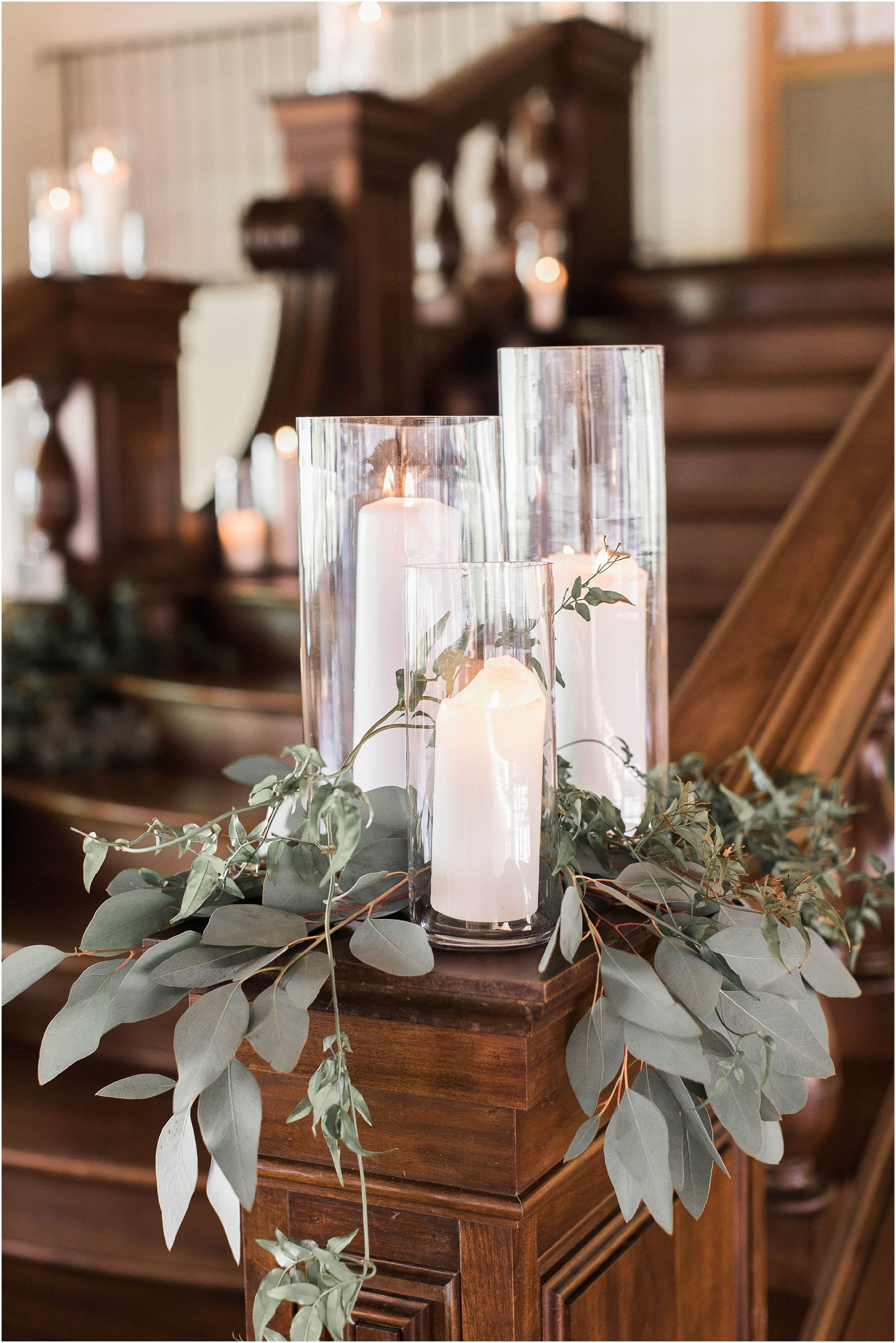 White Pillar Candles In Hurricanes And Gold Details Wedding Decor