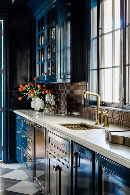 Blue, white and gold butlers feature glossy blue cabinets with brown