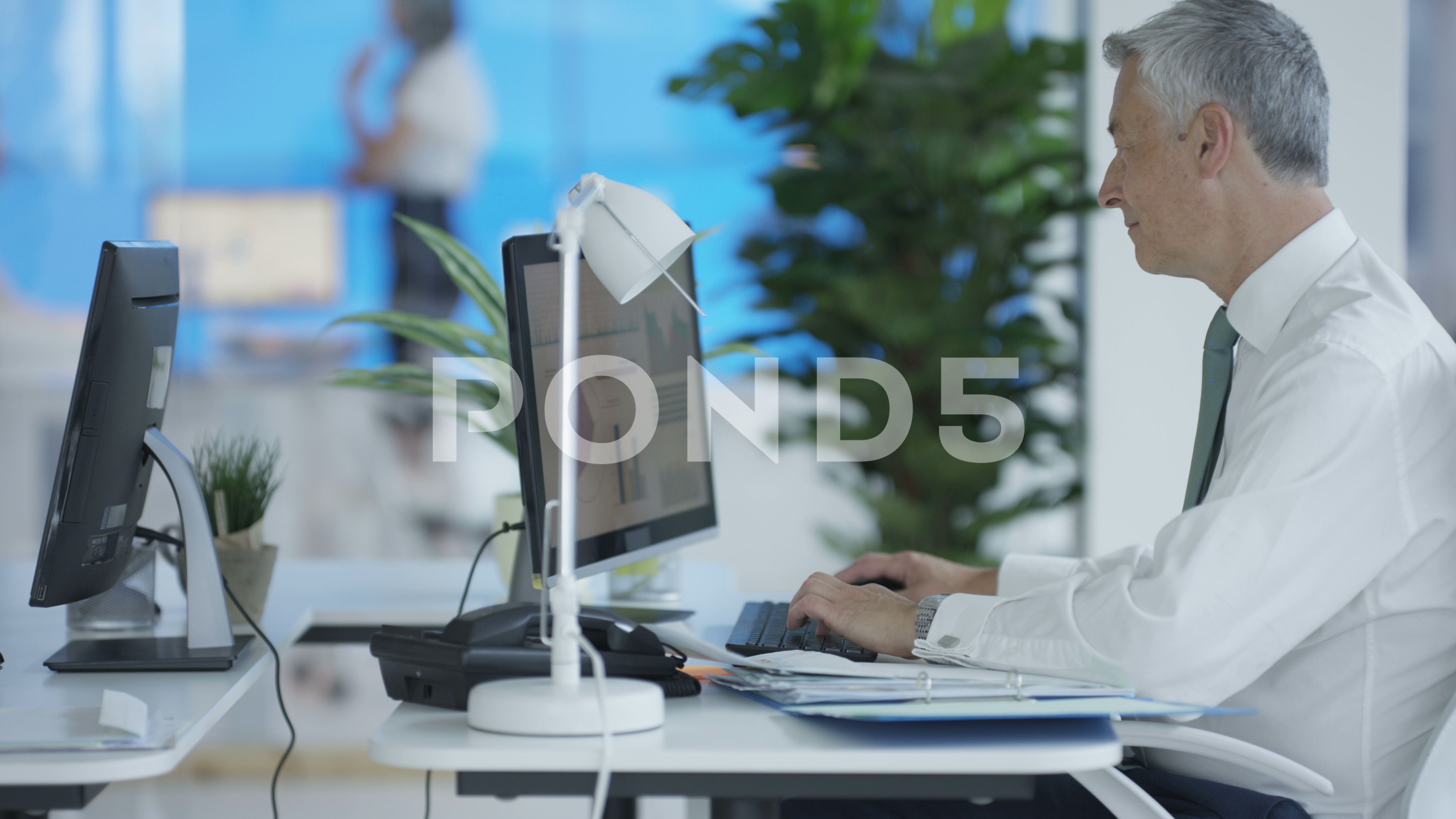 4k Business Colleagues Working At Their Desks In Corporate Office
