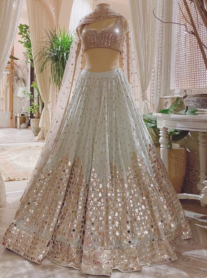 This set features a blue lehenga with floral motif work & mirror embellishments. Comes with a sleeveless blouse & embroidered dupatta. Color: Blue Care: Dry Clean Only Indian Gowns Dresses, Party Wear Indian Dresses, Dress Indian Style, Indian Wedding Outfits, Indian Fashion Dresses, Indian Outfits, Indian Clothes, Indian Attire, Pakistani Dresses