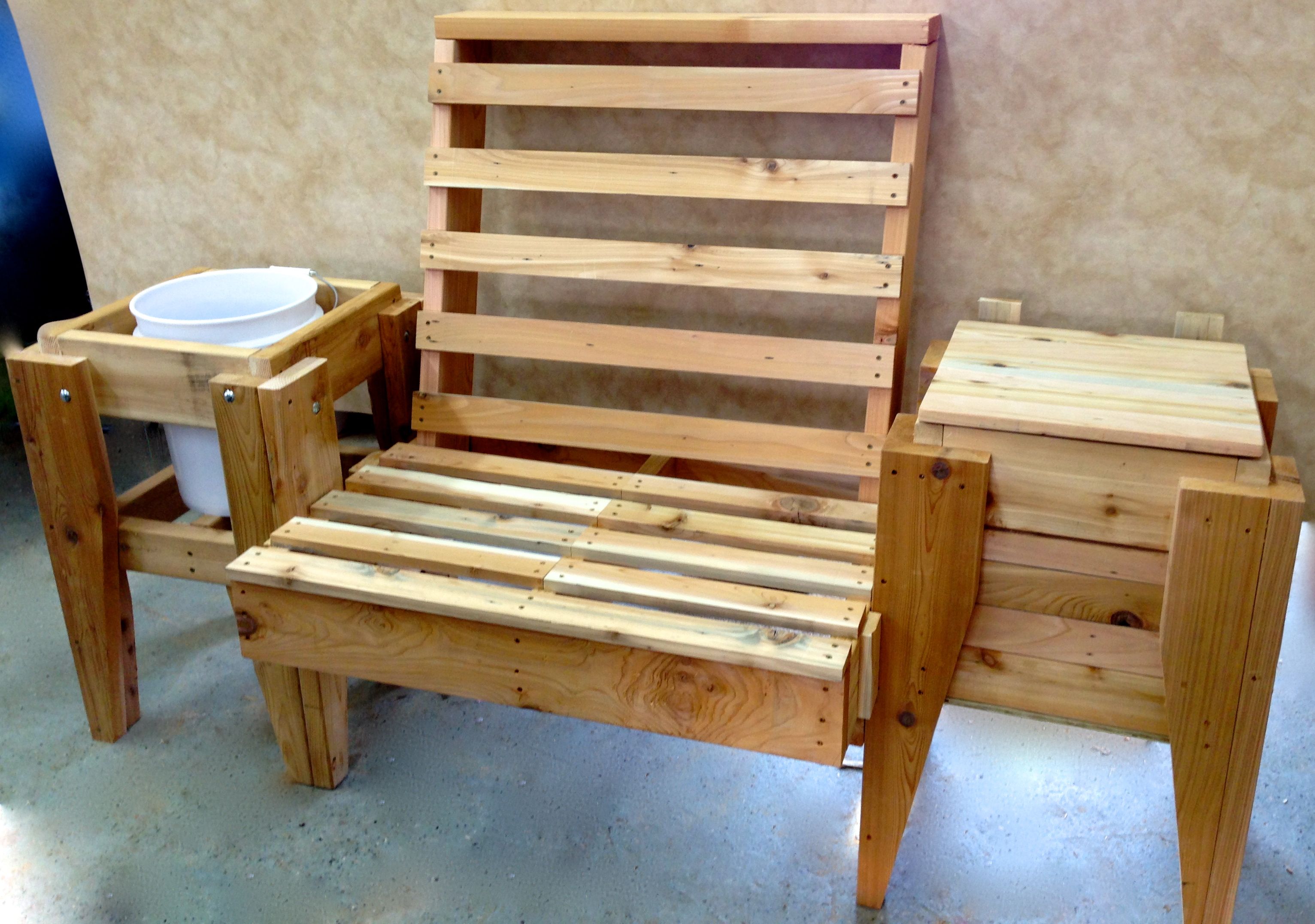 This is a single seat patio chair with a plant unit and a cooler