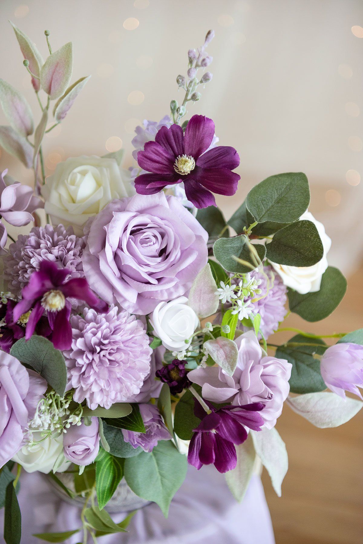 a vase filled with purple and white flowers