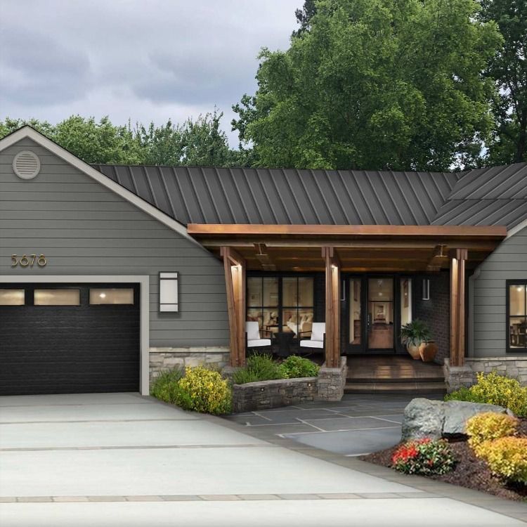 We took a modern/rustic approach to the design of this house with timeless deep rich color palettes and natural textural contrast. We wanted the exterior to reflect the newly renovated interior so we opened up the entry with this exposed wood awning and open pane glass door along with these beautiful windows. We also removed the tree to help expose the house and allow more natural light in. Ranch House Exterior, Lake Houses Exterior, Exterior House Remodel, Home Exterior Makeover, Rustic Exterior, Exterior Paint Colors For House, Modern Farmhouse Exterior, Modern House Exterior, Exterior Design