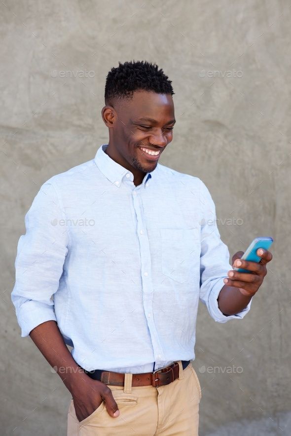 modern young black man reading text message on his mobile phone
