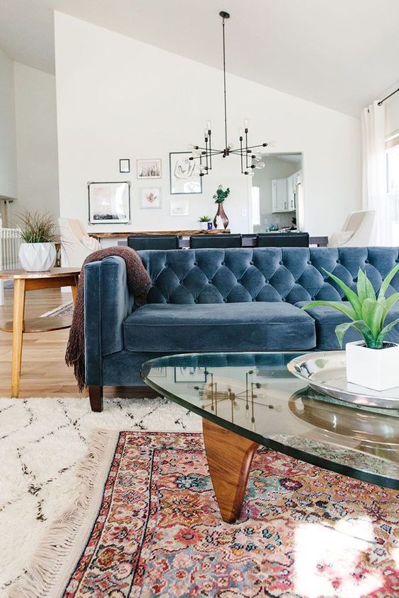A Farmhouse Boho Space With A Muted Blue Chesterfield Sofa That Works As A Space Divider Too Living Decor Home Decor Trends Trending Decor