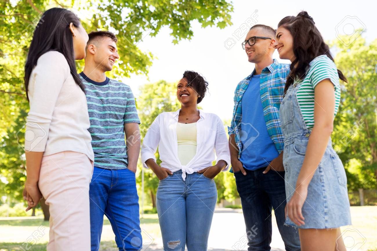 Happy International Friends Talking In Park Stock Photo Spon