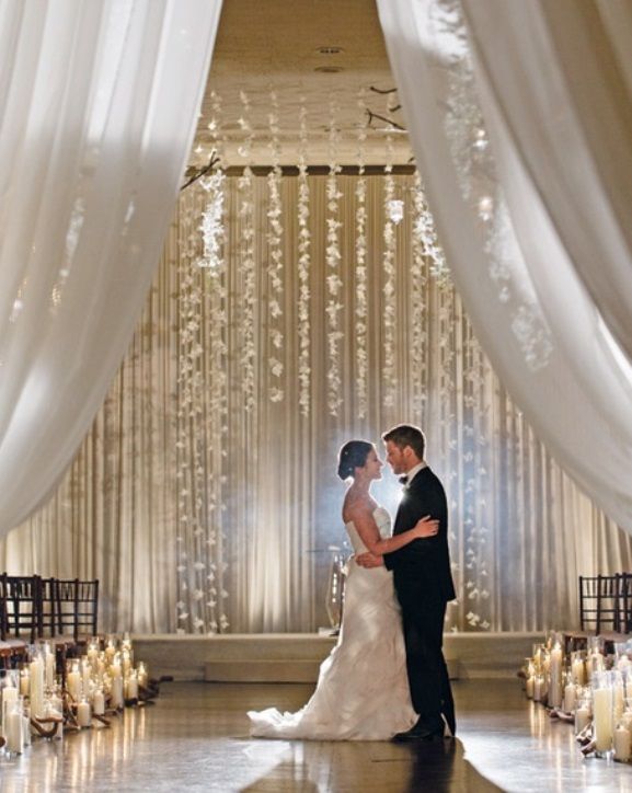 Indoor Wedding Ceremony Elegant Arch Decorations Created Out Of Hanging Flower Cascade In Graduated Lengths Indoor Wedding Ceremony Elegant Arch Decorations Created Out Of Hanging Flower Cascade In Graduated Lengths