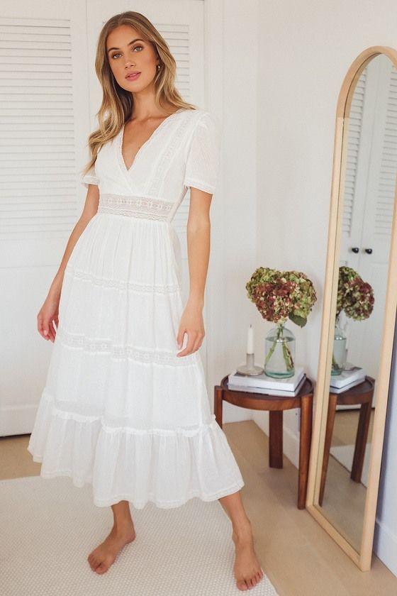 Lulus Exclusive! They'll be telling tales of the girl in the Lulus Folklore White Swiss Dot Lace Tiered Midi Dress for ages to come! Lightweight woven cotton, decked out with trendy Swiss dots, creates a lace-trimmed surplice bodice and short puff sleeves. A band of sheer lace creates a flattering high waist above a dreamy tiered midi skirt, finished off by stripes of lace and ruffles. Hidden side zipper. Fit: This garment fits true to size. Length: Mid-calf length. Size small measures 52" from Dress Cottagecore, Maxi Dress With Sleeves, The Dress, Dress Outfits, Dress Lace, Grad Dresses, Lace Maxi, Lulu's Dresses, Dress Party
