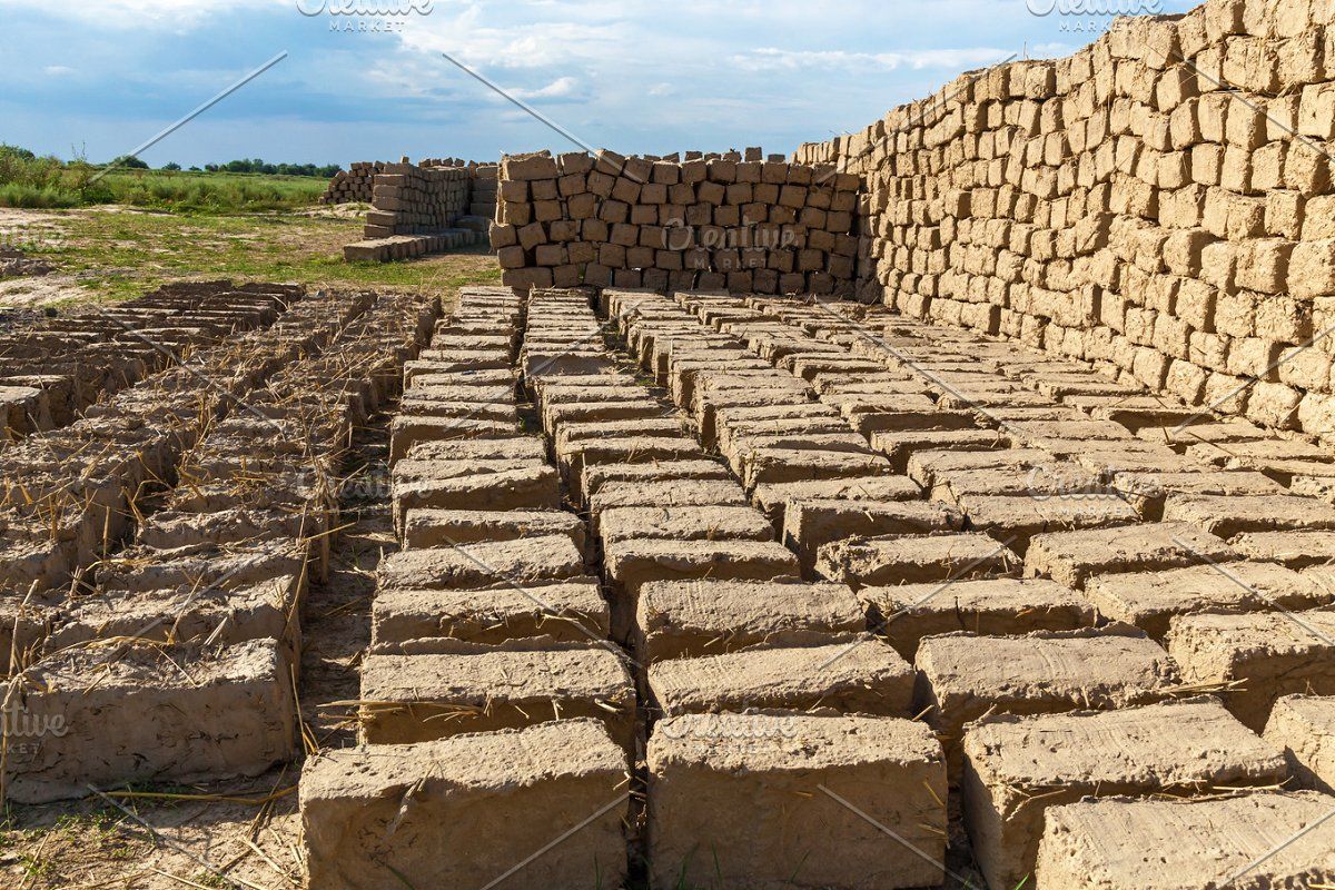 Brick made of clay and straw stock photo containing background and hand