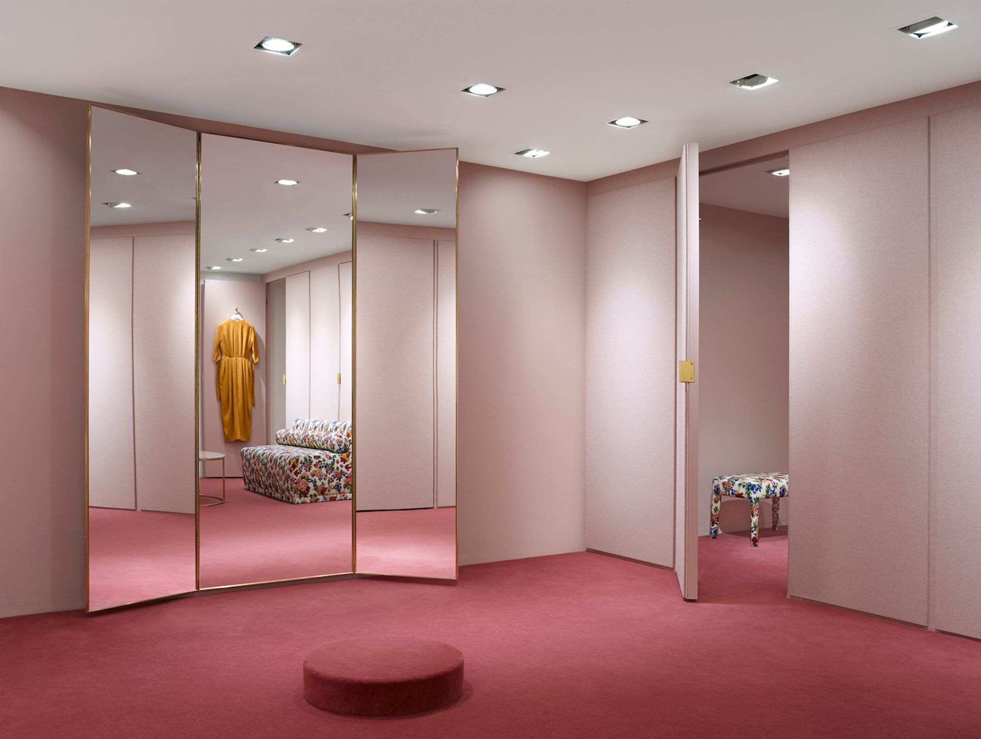 J M Davidson By Universal Design Studio A Doorway Framed With The Same Gold Coloured Metal Conceals A Dressing Room Design Luxury Wardrobe Boutique Interior