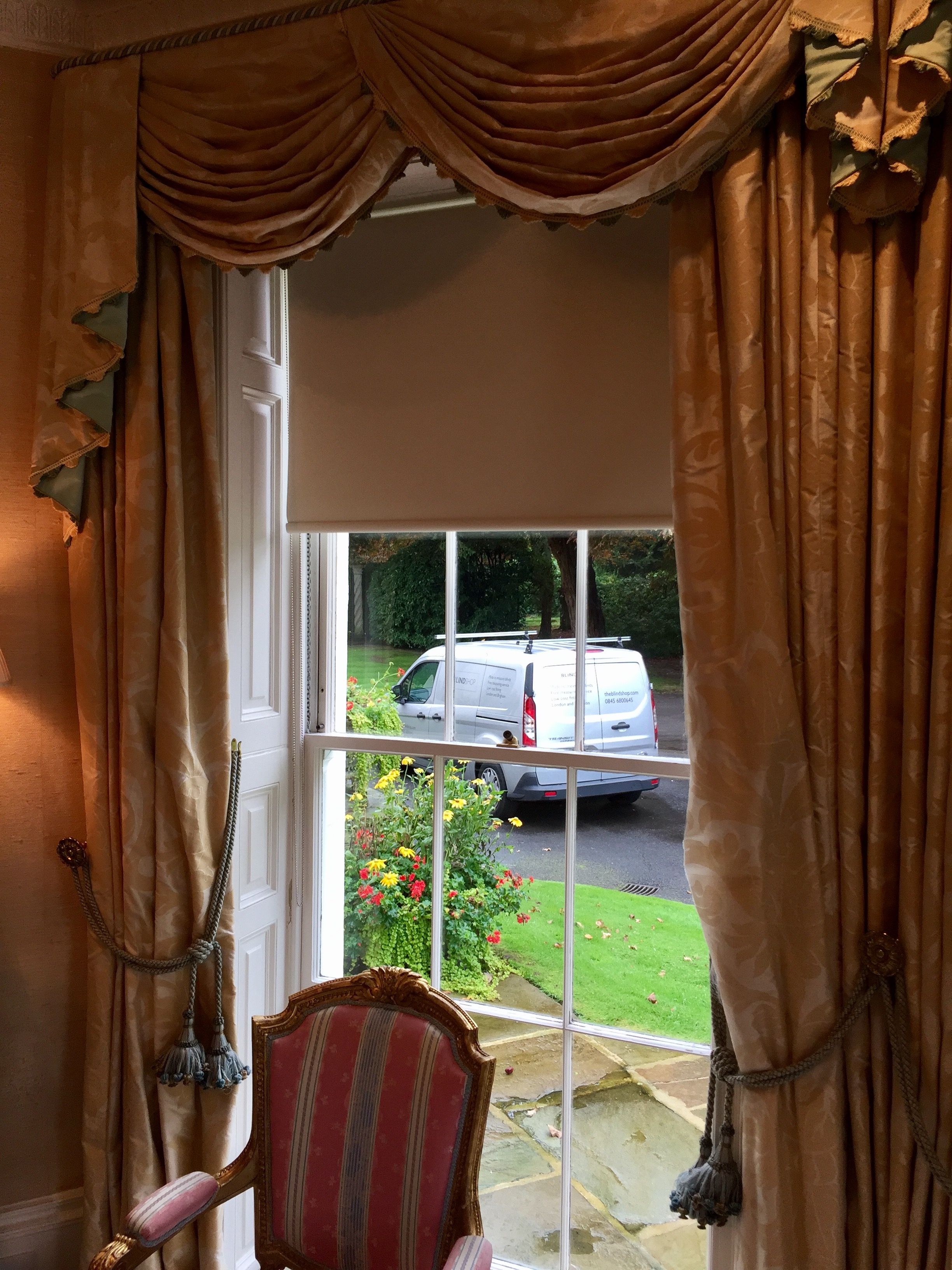 Blackout roller blind with curtain installed in historic