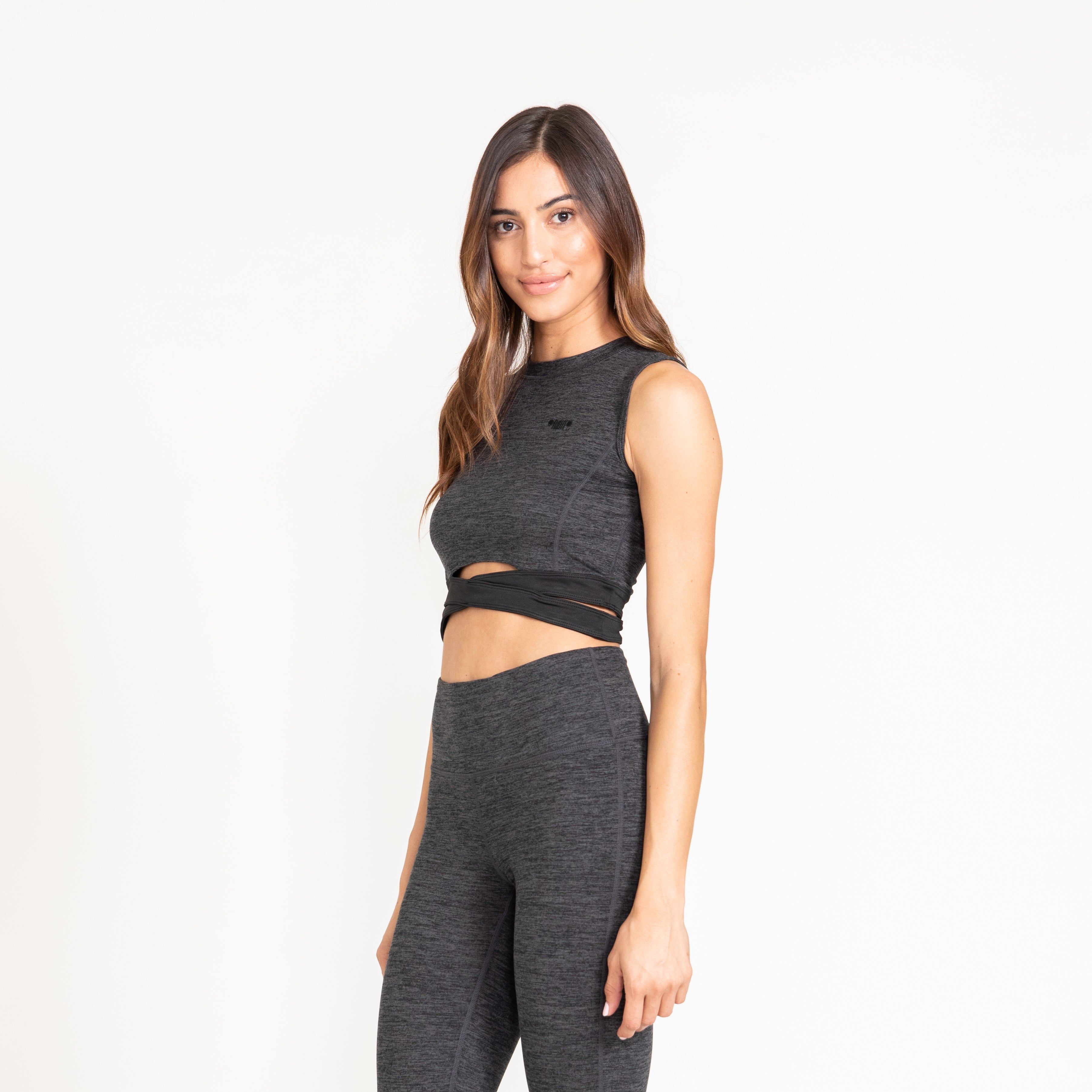 Sleeveless crop top with two tones features flattering seam lines on the front as well as wrap-around crisscross elasticized ribband