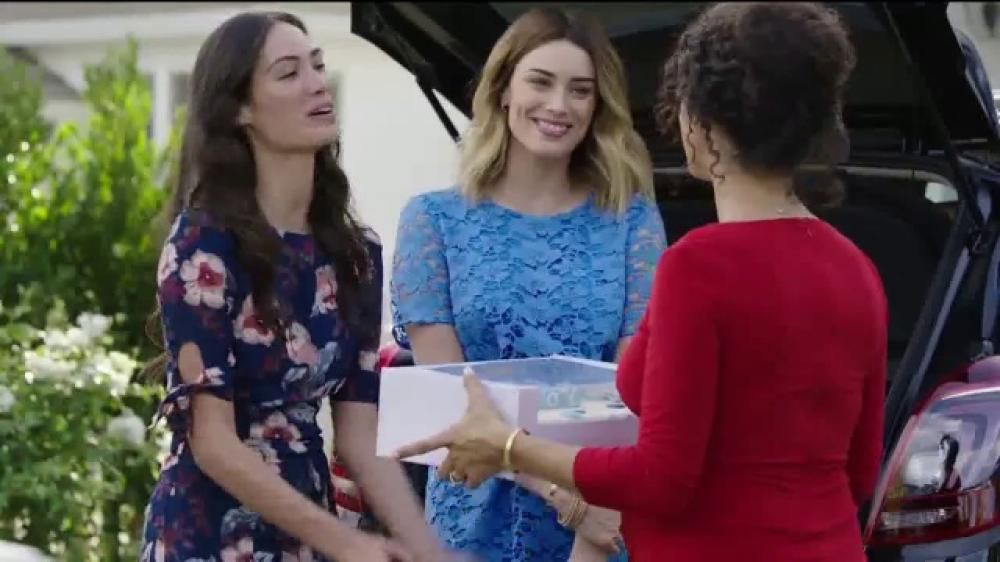 Two Women Are On Their Way To A Baby Shower With Gifts And A