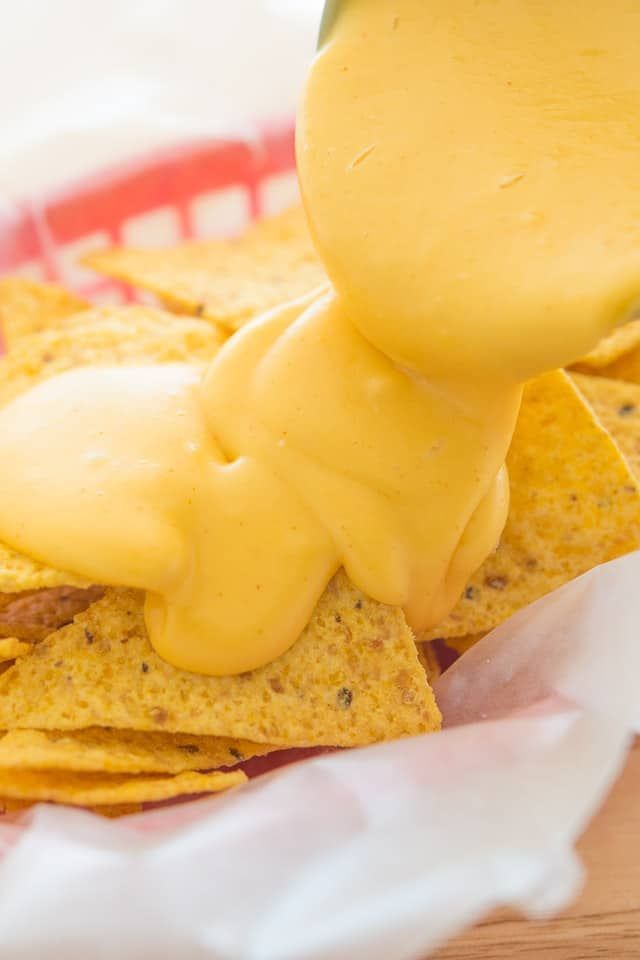 Nacho Cheese is easy to make yourself from scratch, and is the perfect melty sauce to pour over tortilla chips. This Nacho Cheese Sauce is made with only five all-natural ingredients, and takes 10 minutes to make. via @fifteenspatulas Homemade Nacho Cheese Sauce, Nachos Cheese Recipe, How To Make Cheese Sauce, Homemade Nachos, Cheddar Cheese Sauce, Cheese Sauce Recipe, Cheese Fries, Homemade Recipes, Snacks