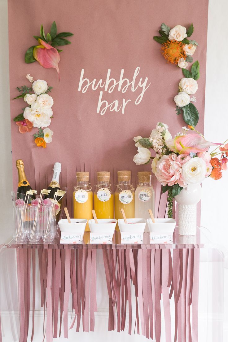 Juices and champagne on a table with a backdrop of flowers and bubbly bar sign as an idea for bridal shower decorations Mimosa Bar Bridal, Bridal Brunch, Bridal Party, Diy Bridal, Boho Bridal, Mimosa Bar Sign, Berta Bridal, Wedding Parties, Classy Bachelorette Party
