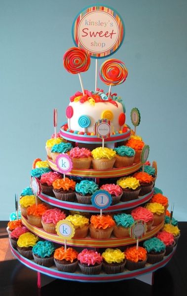 Picture this with the words "Hudson's Depot" instead of sweet shop. It wil be christmas colors with the lollipops and a noth pole sign at the top. The cupcakes will have little fondant trains on them!! Yeah Polar Express b-day party!! Cardboard Cupcake Stand, Cake And Cupcake Stand, Cupcake Display, Cupcake Tower, Cupcake Party, Cupcake Cakes, Rainbow Birthday Party, 1st Birthday Parties, Rainbow Theme