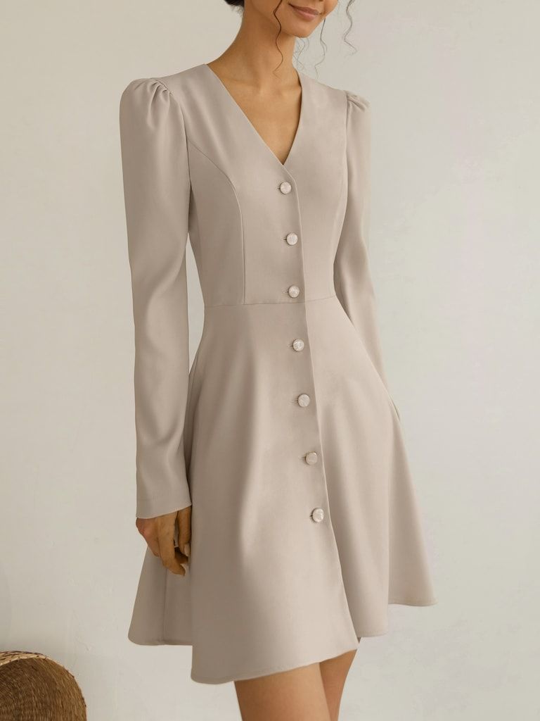 This fine mini dress tailored for a slightly close fit has a flattering V-neckline, charmingly puffed shoulders and a flared mini-length hem. Cut from a smooth yet dense fabric with a refined appearance, the style is detailed a row of sizeable buttons through the front. - mini-length hem - slightly close fit - V-neckline - puffed shoulders - flared skirt - button fastening through the Elegant Dresses, Cute Dresses, Beautiful Dresses, Vintage Dresses, Casual Dresses, Fashion Dresses, Tailored Dresses For Women, Elegant Feminine Outfits, Simple Dresses Casual Cute