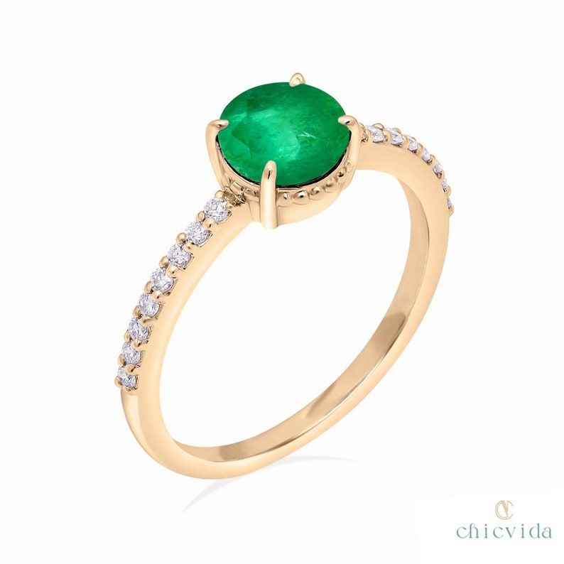 ★ DetailsMaterial: 14k/18k goldColor Options: Yellow Gold, White Gold, Rose Gold★ Center Stone:Natural Emerald, RoundSize: 6 mmApprox Weight (Ct): 0.54★ Accent Stones: Diamond RoundSize: 1.2 mm * 16 Nos.Approx Weight (Ct): 0.12Diamond Color-Clarity: G Color Si Clarity★ Ring Height: 6.5 mm★ Band Width: 1.5 mm White Rose Gold, 18k Rose Gold, 18k Gold, Yellow Gold, Recycled Gold, Natural Emerald, Emerald Ring, 14k Solid Gold, Center Stone
