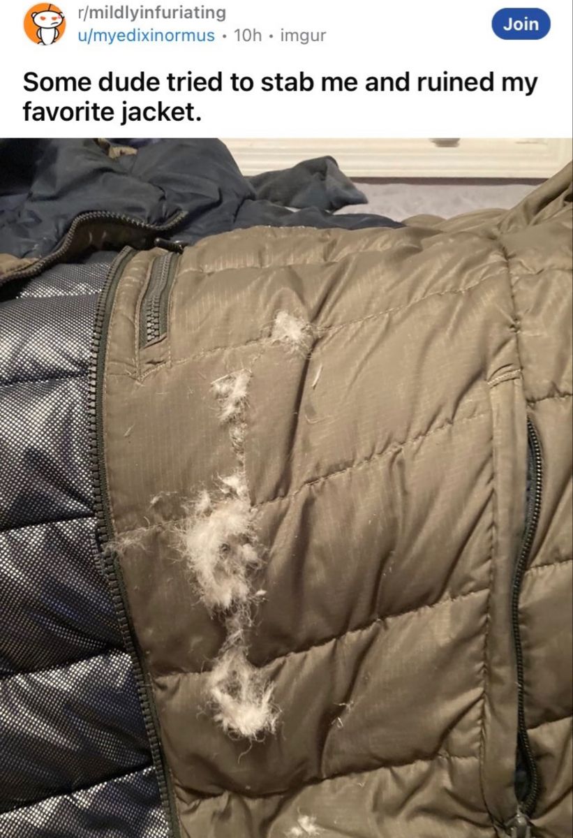A Jacket That Has Been Ripped And Is Sitting On Top Of Another Jacket a-jacket-that-has-been-ripped-and-is-sitting-on-top-of-another-jacket