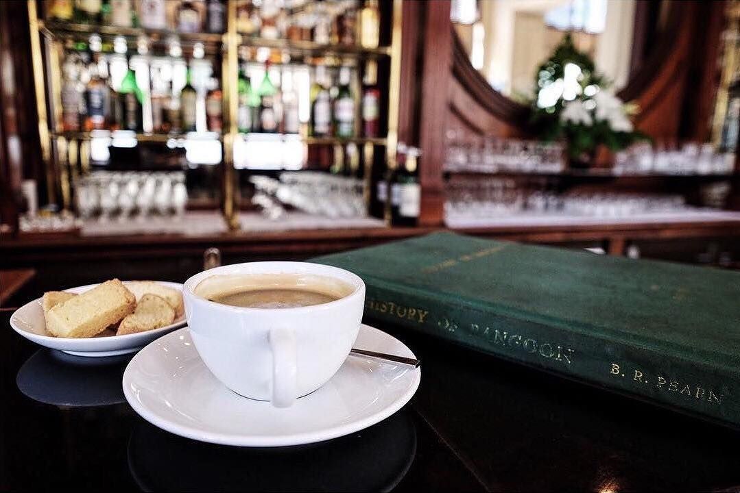 Agoda Com On Instagram Themapdept Enjoys A Cup Of Coffee And A Good Read At The Strand Hotel In Yangon Myanmar Over A Century Old The Strand Is One Of The