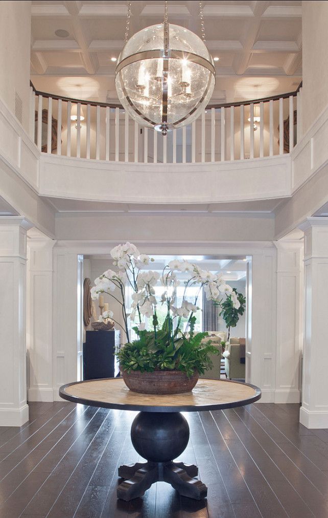 This two story foyer is simply elegant we love the chandelier in particular from brooke wagner design