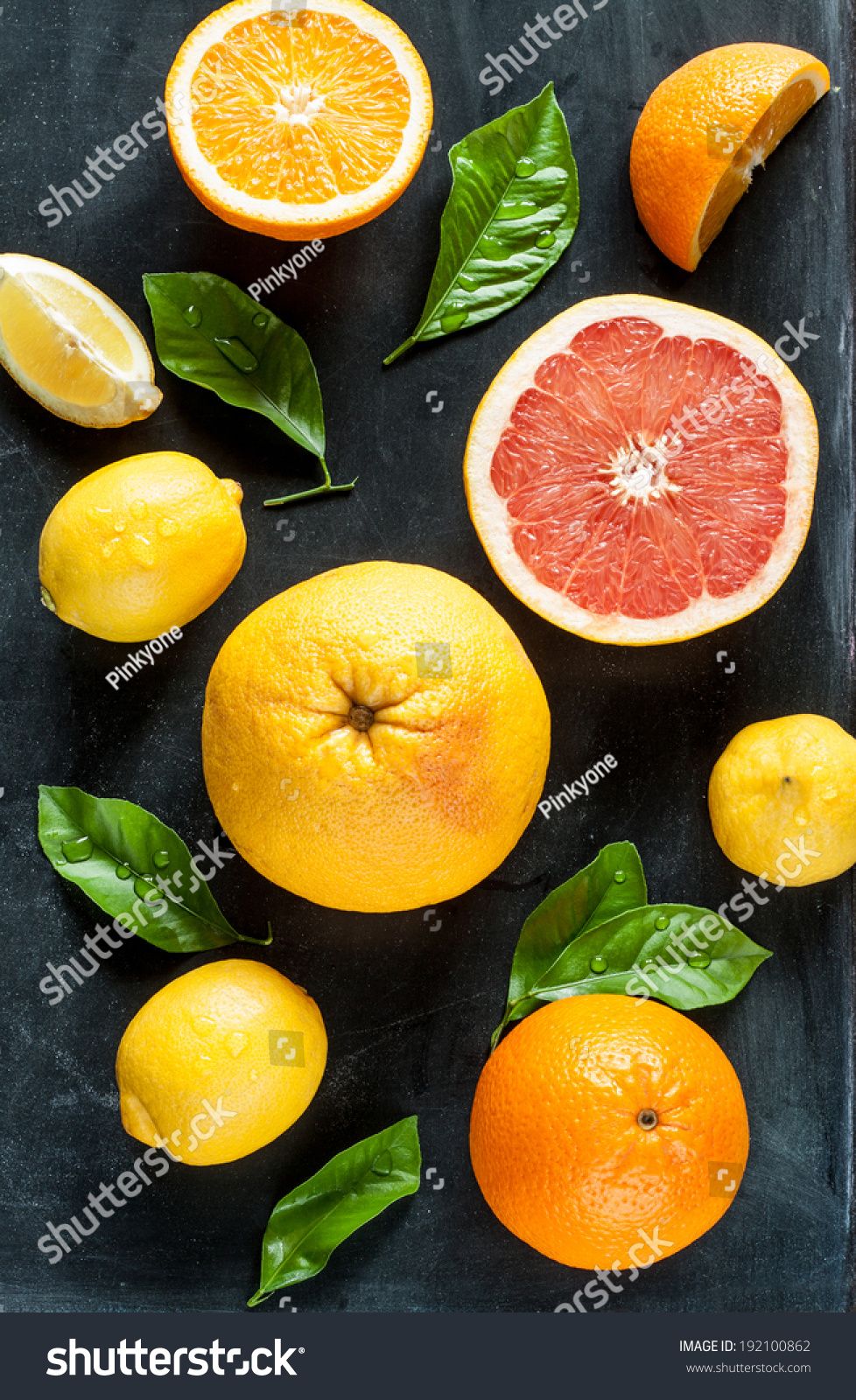 Citrus fruits (lemon, grapefruit and orange) with fresh wet leaves on black chalkboard background - still life from above Tasty, Delicious, Grapefruit, Clean Eating, Lemon, Stock Photos, Fresh, Orange, Chalkboard Background
