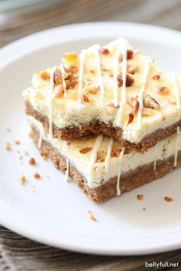 Eggnog Cheesecake Bars with White Chocolate Drizzle #eggnogcheesecake These Eggnog Cheesecake Bars are luscious cheesecake in bar form, with an eggnog flair, and drizzled with melted white chocolate! #cheesecakebars #cheesecakebarsrecipes #eggnogcheesecake #eggnogcheesecake
